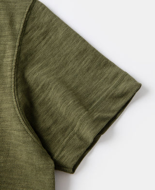 Green cotton T-shirt sleeve cuff with tubular gusset stitching