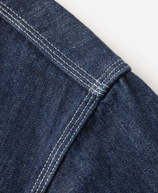 Dark blue denim workshirt sleeve seam with double-stitched panel detail