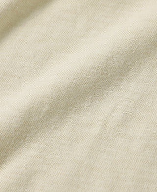 Cream white slub cotton T-shirt fabric close-up showing subtle slub weave