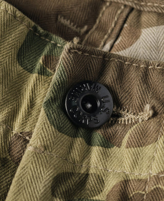 Camouflage herringbone cloth with black marked button detail