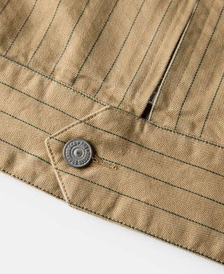 Khaki striped chore coat hem with two snap buttons and stitched panel