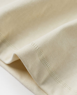 Long-sleeve henley cuff and sleeve seam in light cream knit fabric