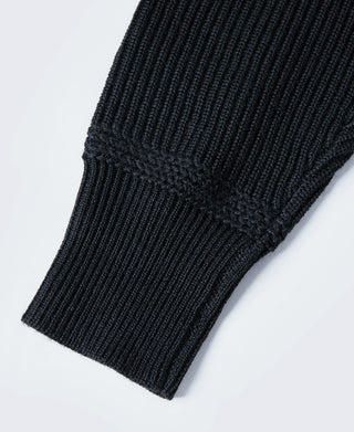 Navy wool sweater sleeve cuff with ribbed knit texture
