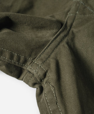 Olive Bermuda pants cuff with button tab and stitched hem details