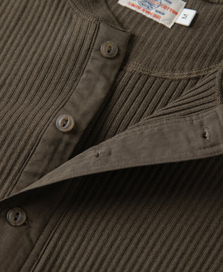 Olive-brown henley placket with round buttons and ribbed collar detail