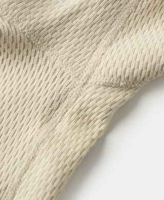 Thermal waffle-knit shirt sleeve knit texture in light apricot/cream