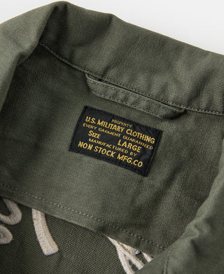 Olive fabric care label patch inside collar area