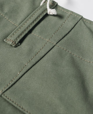 Olive waistband pocket close-up with bar tack stitching and interior seam
