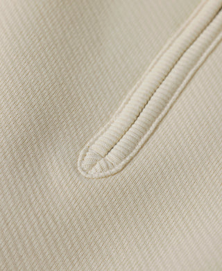 Apricot ribbed fleece edge detail with stitched seam near the zipper