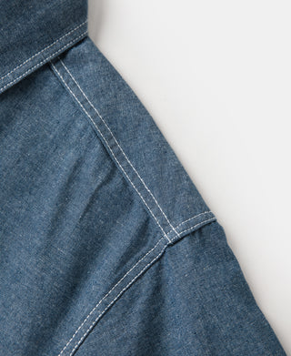 Blue chambray work shirt sleeve with contrast-stitched seam detail