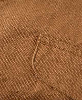 Canvas vest side pocket with curved flap and stitched edge