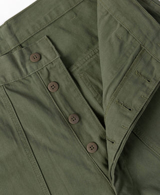 Olive utility pants front with multiple brown buttons and pocket flaps
