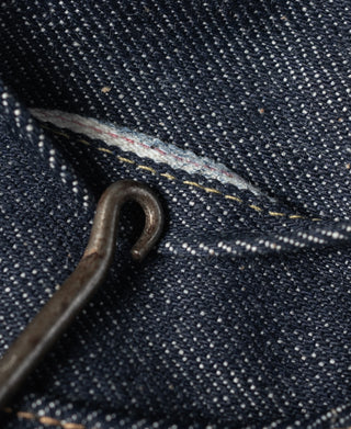 Dark blue denim with metal eyelet and bar-tack stitching on interior seam