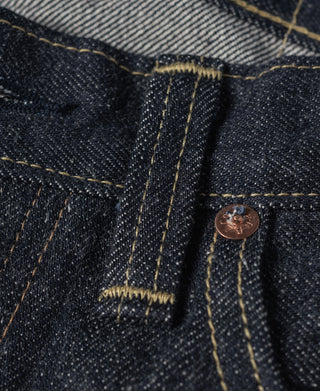 Indigo denim inner waistband and belt loops with copper-tone button