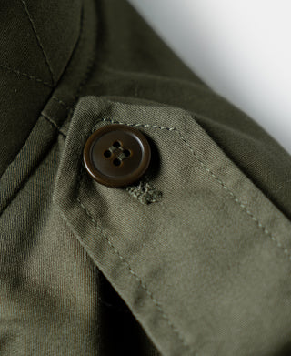 Olive flight jacket button on pocket flap with stitched seam details