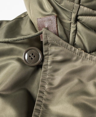 Olive N-3 parka front with dark button and stitched placket detail.
