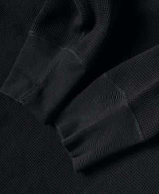 Black waffle cotton underwear with elastic waistband, folded for display