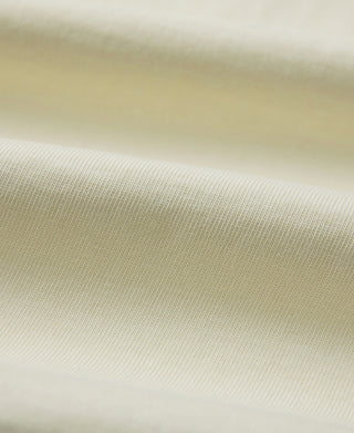 Cream henley T-shirt fabric close-up with fine knit texture