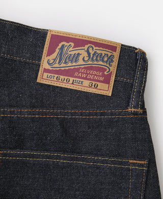 Selvedge denim jeans fabric label at waistband: "Non Stock" "Lot 600" "Raw Denim 30"