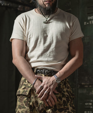 Light apricot crew-neck slub cotton T-shirt worn with camouflage shorts
