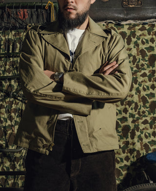 Olive green field jacket with full sleeves, button front, and utility pocket