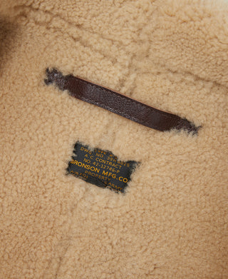 Tan shearling interior panel with stitched brand label