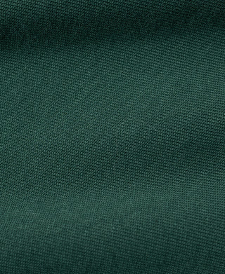 Green T-shirt knit fabric texture close-up, fine weave and even finish.