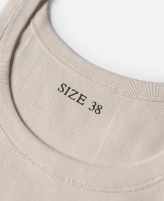 Cotton tank top neckline in light cream with 'SIZE 38' printed on ribbed trim
