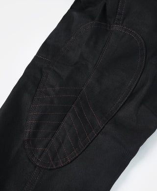 Black breeches with curved pocket opening and detailed stitched panel.