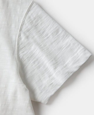 White cotton t-shirt sleeve close-up with hem finish
