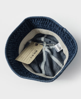 Indigo denim bucket hat interior with stitched band and hanging tags