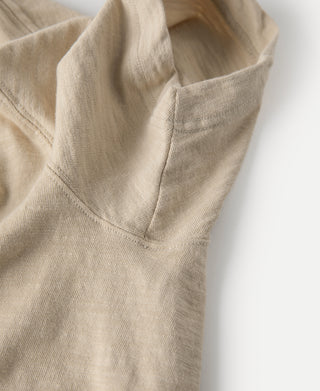 Light tan T-shirt neckline and shoulder seam close-up