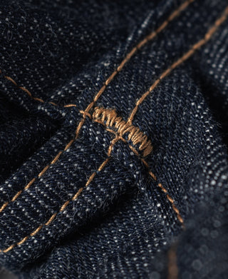 Indigo denim close-up of reinforced seam with copper thread stitching