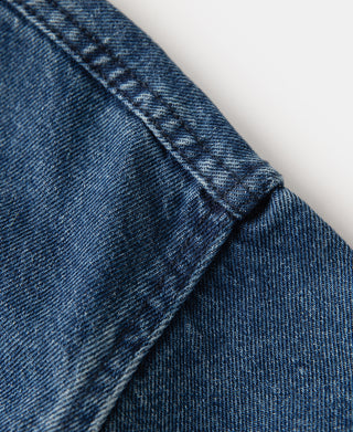 Stonewashed indigo denim work jacket shoulder yoke with contrast topstitching