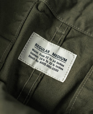 Olive fatigue pants with Regular Medium size label on waistband