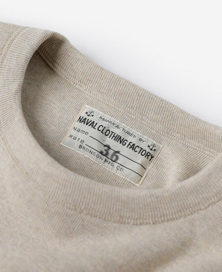 Crewneck undershirt neckline label on light heather beige knit collar