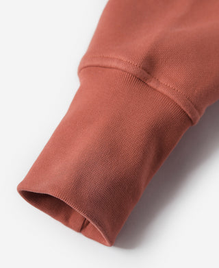 Brick red terry cloth hoodie sleeve cuff with ribbed hem
