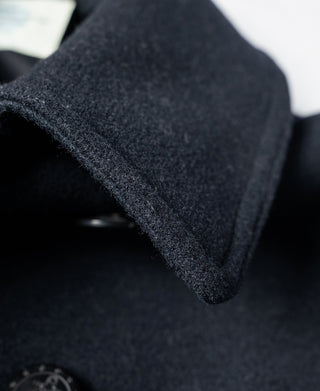 Navy peacoat collar fold and neck button close-up