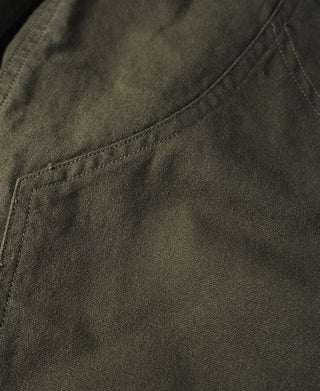 Close-up of olive cotton canvas stitching on climbing pants
