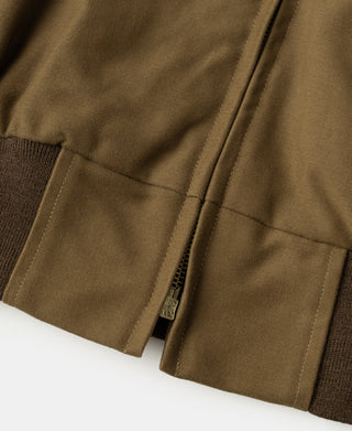 Brown bomber jacket side pocket welt and stitched hem with small brand tag.
