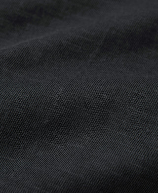 Close-up of black slub cotton fabric texture on the T-shirt