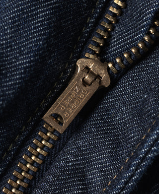 Indigo denim zipper fly with metal zipper pull and stitched opening