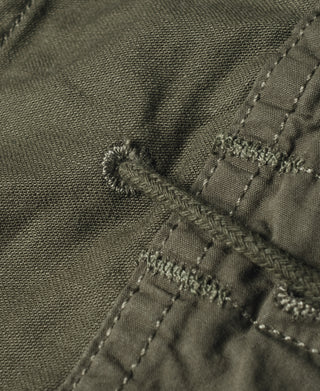 Olive field jacket close-up of stitched vent area and reinforced edge seams