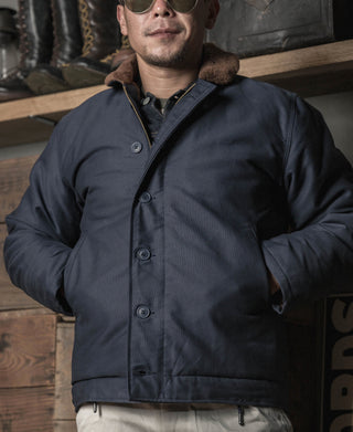 Navy N-1 deck jacket with shearling-lined hood collar and front button placket