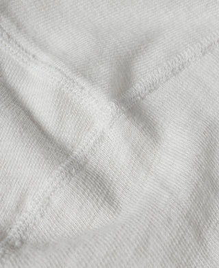 White henley T-shirt fabric close-up with subtle weave texture