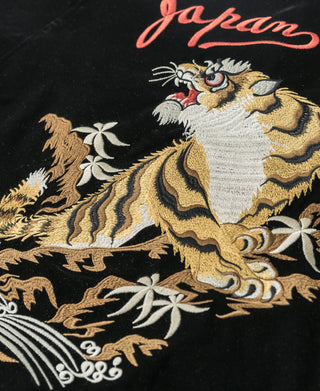 Black jacket with 'japan' script embroidery and tiger graphic in gold and white thread.