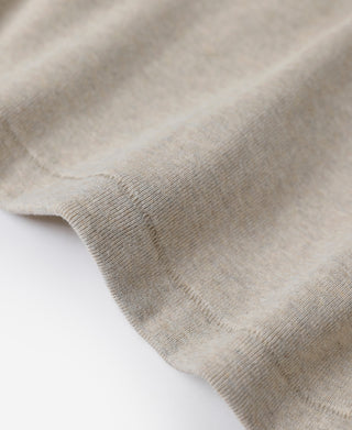 Light heather beige undershirt fabric close-up with fine knit texture