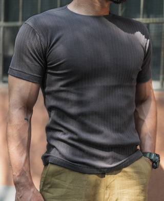 Dark gray ribbed T-shirt on model, crew neck and short sleeves