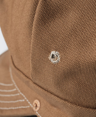 Ginger duck canvas cap close-up with front eyelet patch and stitched seam detail
