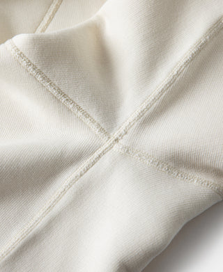 White raglan sweatshirt cross-seam detail at shoulder and body